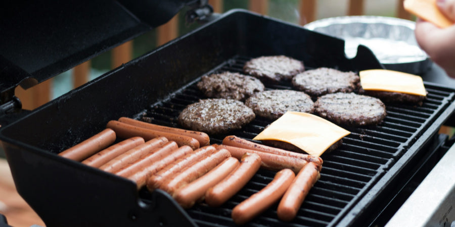 burgers and hot dogs on grill