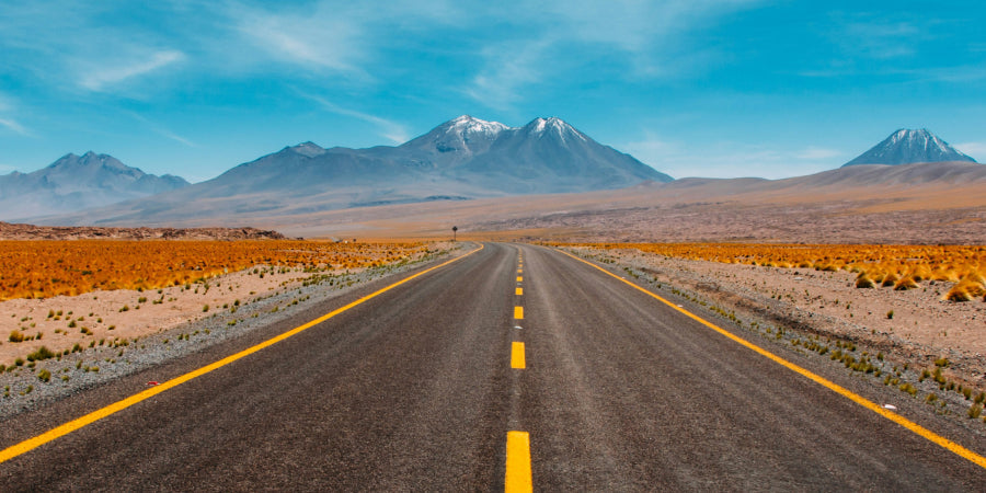 road through dessert with mountain in backbround